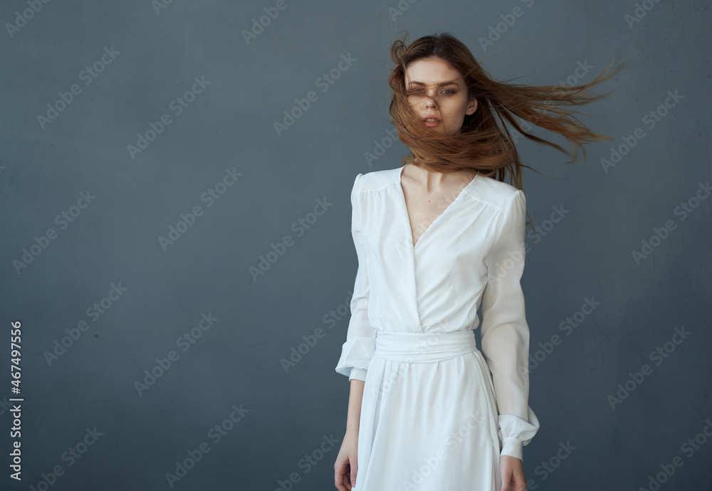 Fototapeta premium Woman in white dress charm basing fashion hairstyle performance