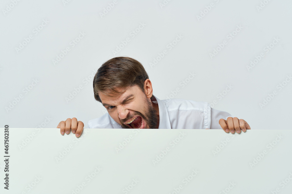 Cheerful man white banner in hand blank sheet presentation isolated background Cheerful man white banner in hand blank sheet presentation isolated background
