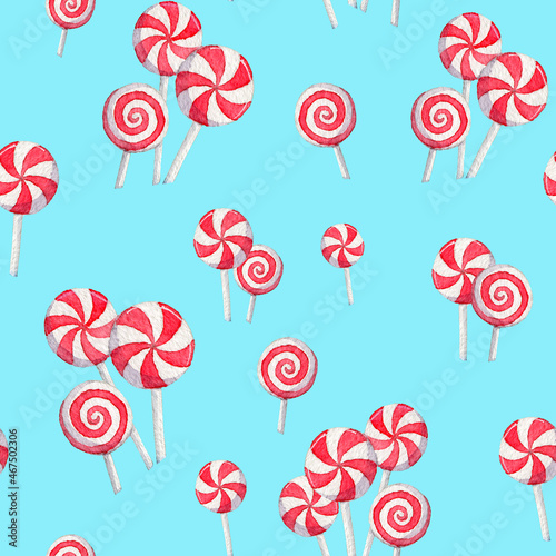 Christmas seamless pattern with hand drawn red candy cane on blue background. Seamless pattern with watercolor candies and lollipops. Illustration for wrapping paper, fabric, greeting cards design.