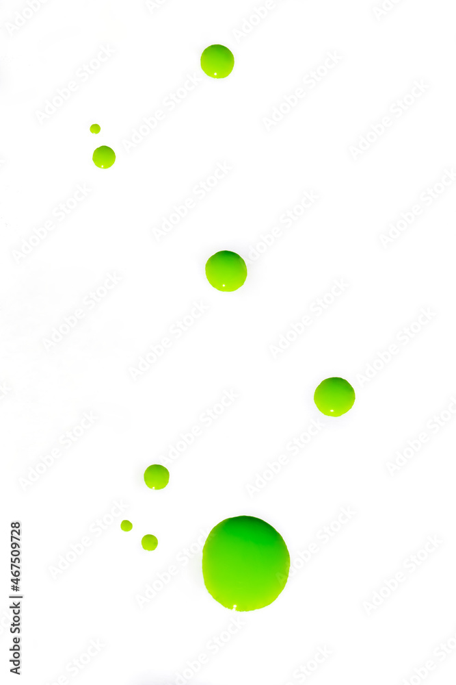 Attractive bright abstract background: drops of luminescent green varnish on a white surface Attractive bright abstract background: drops of luminescent green varnish on a white surface