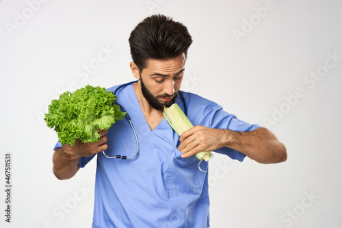 Cheerful dietitian doctor with vegetables in hands stethoscope treatment