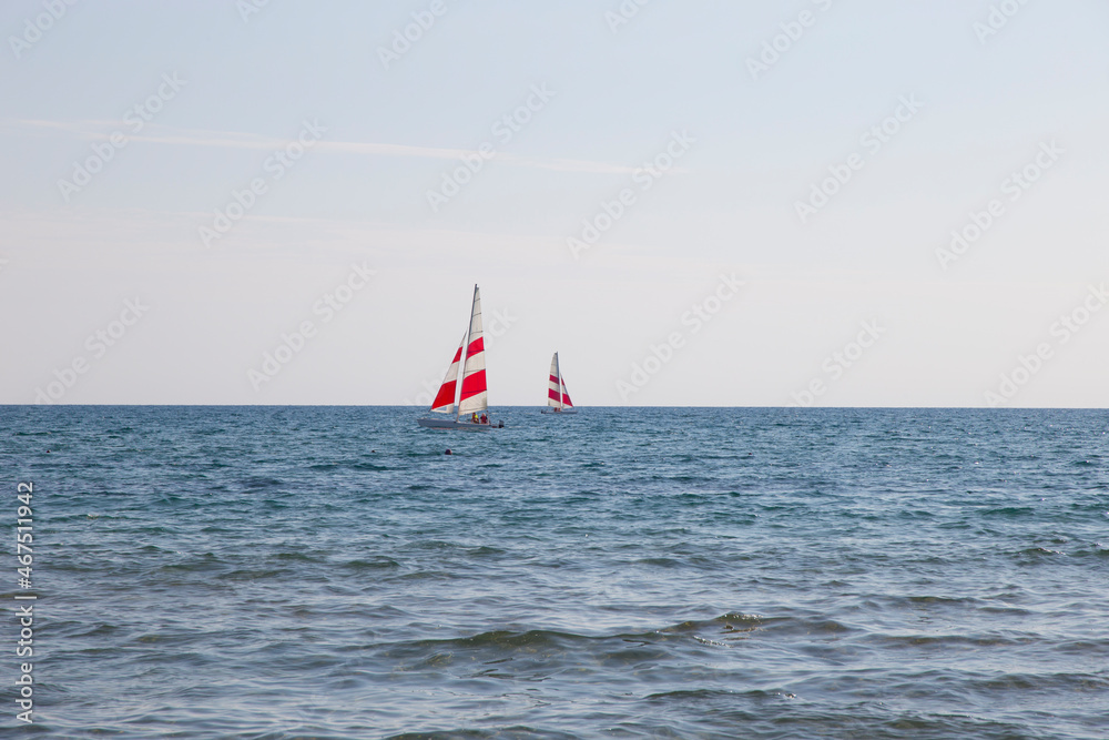 Fototapeta premium Two Windsurfing yachts on the horizon