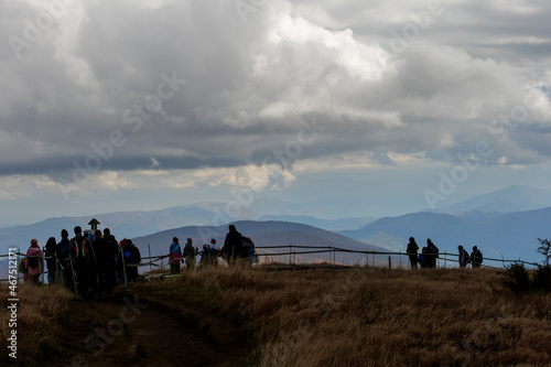 Bieszczady Polish mountains view from Wielka Rawka, autumn, nice weather, mountain peaks, clouds, people admiring the mountains, people looking at the mountain peaks