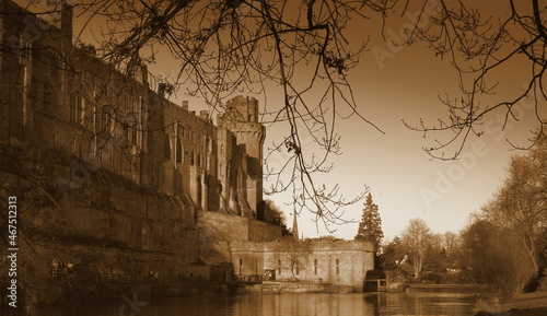 old British Castle in warwick westmidlands in golden autumn light with the blue sky background during autumn photo