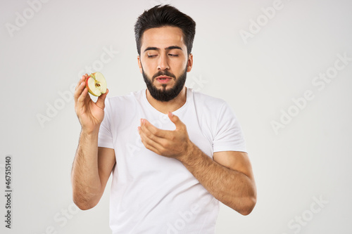 emotional bearded man with apple in his hands fruit snack