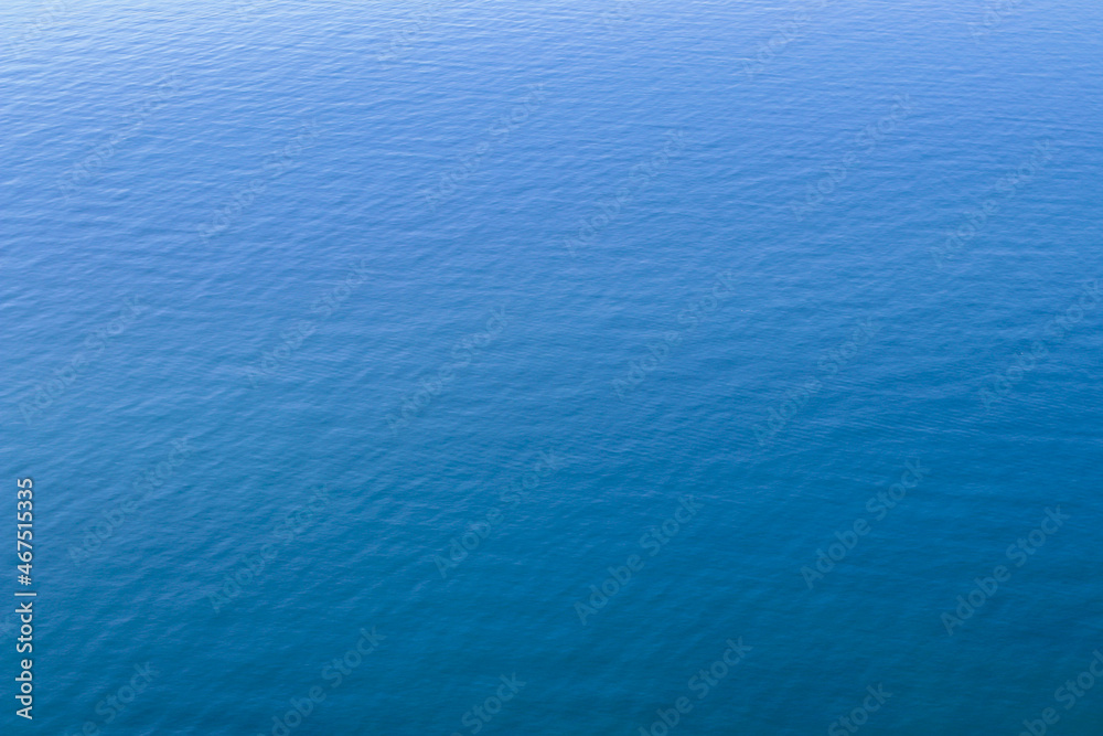 Obraz premium Calm clear blue sea water background. Blue azure sea water texture.