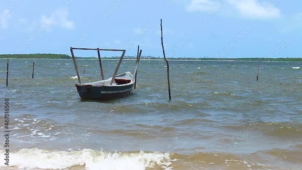 Small fisherman's barge moored at the edge of the sea.