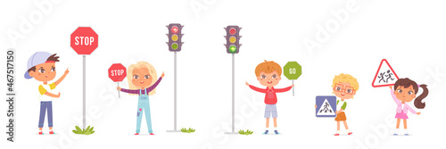 Group of preschool children studying traffic rules, holding road signs in their hands, traffic without stopping is prohibited, attention children, crossing the road at permitting traffic light. photo