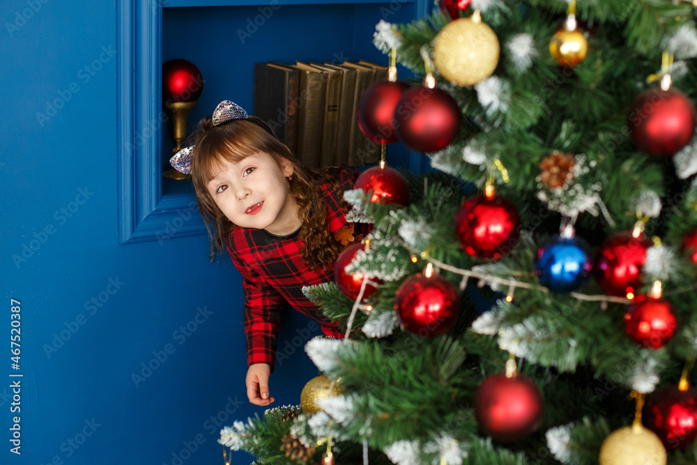 Xmas party celebration. Christmas happy child near Christmas tree. Winter holiday and vacation