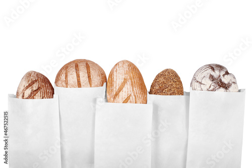 Different breads in paper bags on a white background isolate