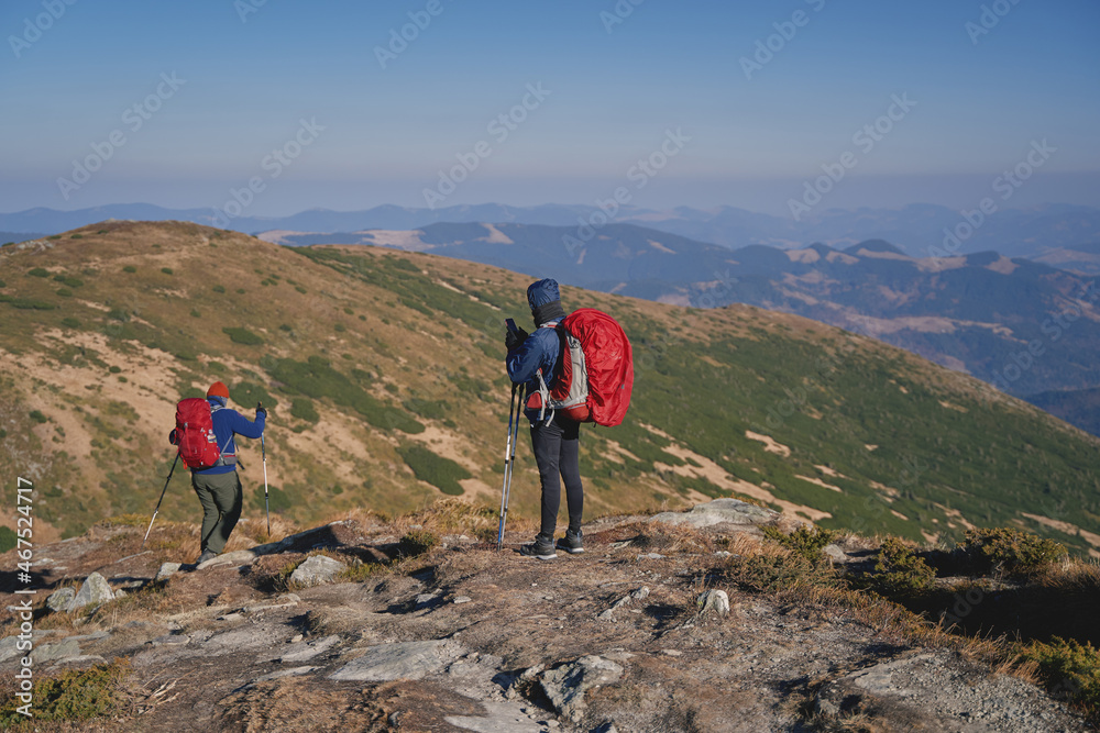 Tourists with backpacks at the top of the ridge. Ukrainian Carpathian mountains. Chornohora ridge.