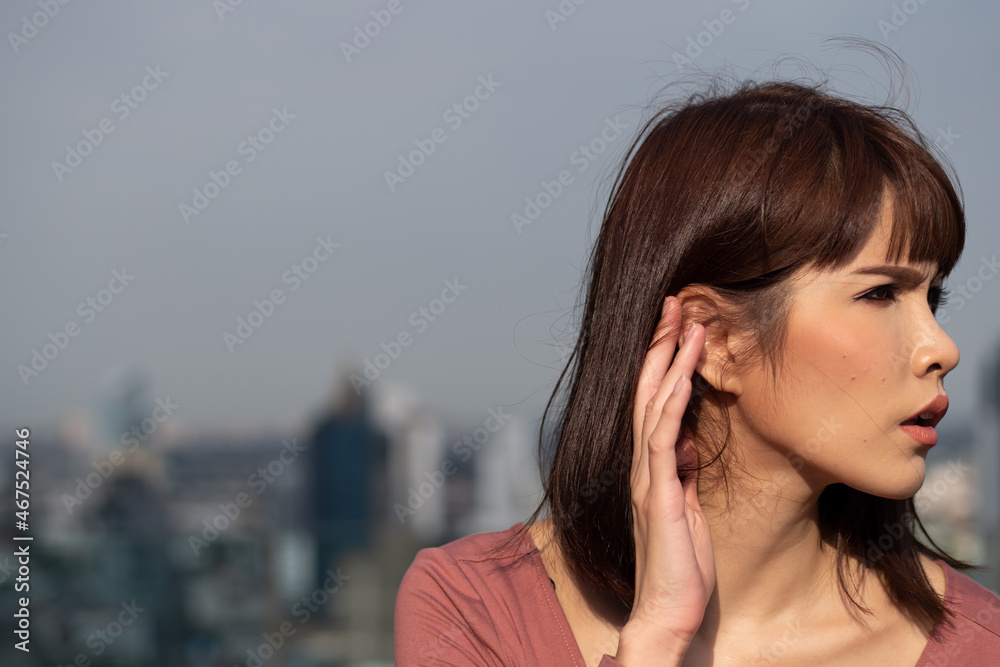 woman having hearing loss or hearing problem