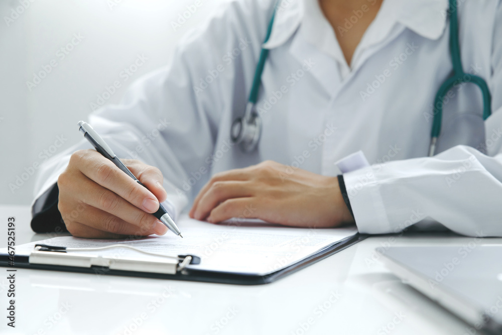 Close up Doctor hand writing down patient details with a pen at the hospital. concept of attention to details. Close up Doctor hand writing down patient details with a pen at the hospital. concept of attention to details.