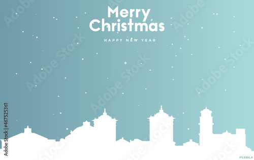 Christmas and new year blue greeting card with white cityscape of Puebla City