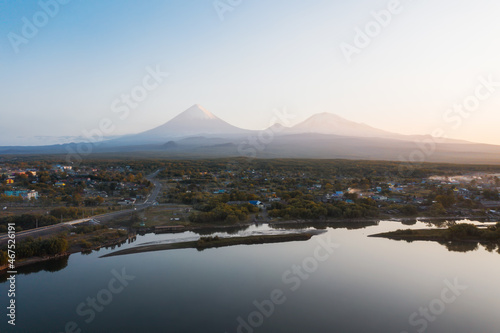 Klyuchi village, Kamchatka river, drone view. Klyuchevskaya volcano on the background photo