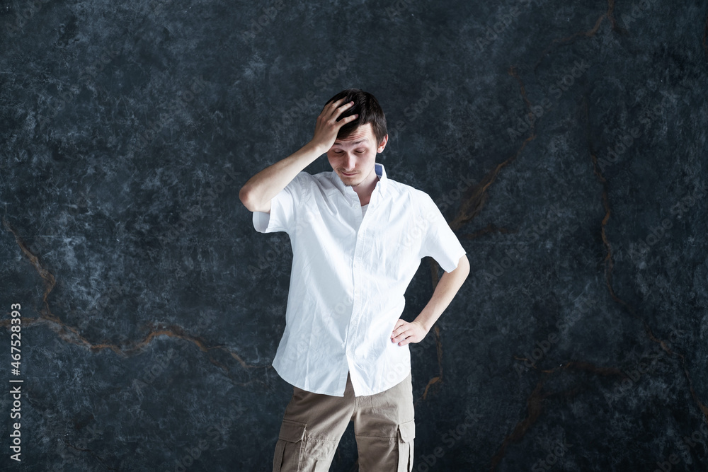 Expressive portrait of a man holding his head with his hand Expressive portrait of a man holding his head with his hand