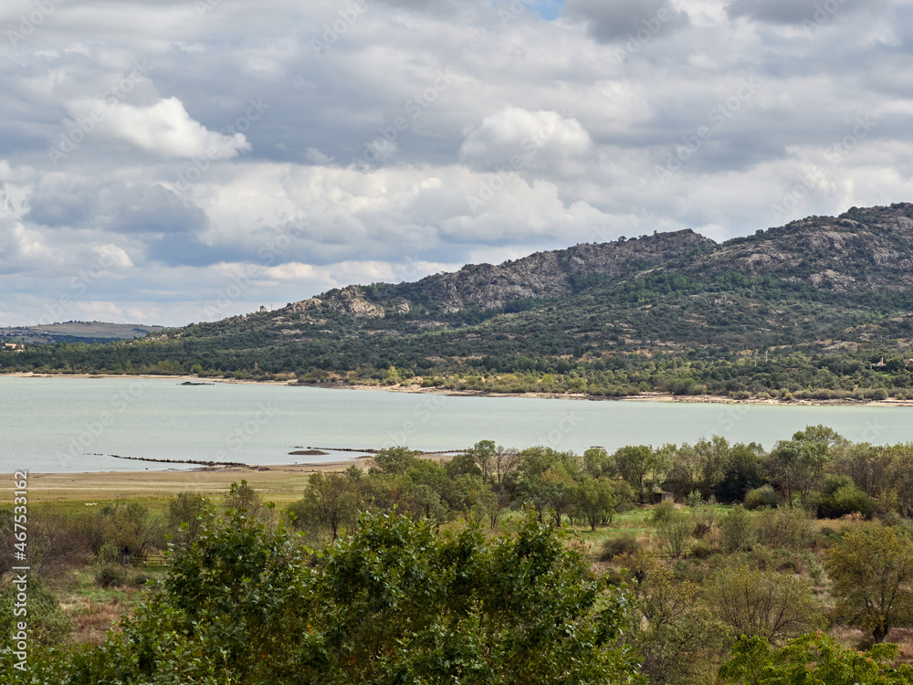 Landscape of Santillana reservoir, a lake in Manzanares el Real in a cloudy day. It is part of Parque Regional de la Cuenca Alta del Manzanares. Community of Madrid, Spain. Europe