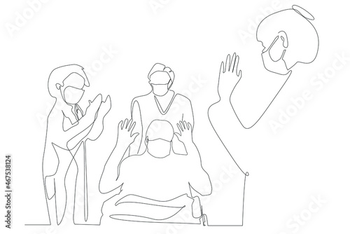 The doctors, who gave moral support to the recovered patient who survived his illness, applaud. The patient who recovered from the corona virus epidemic disease is taken with a wheelchair