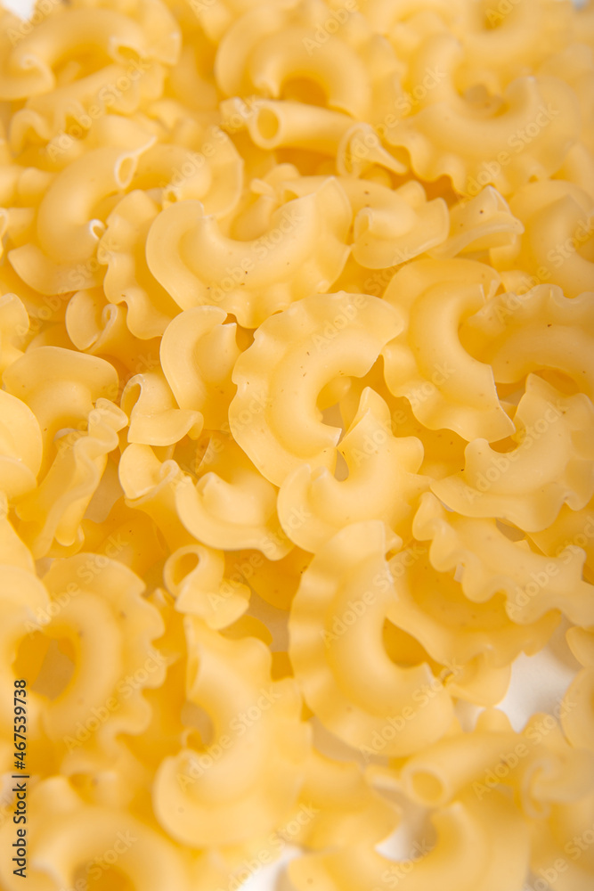Close up of raw creste di gallo pasta background