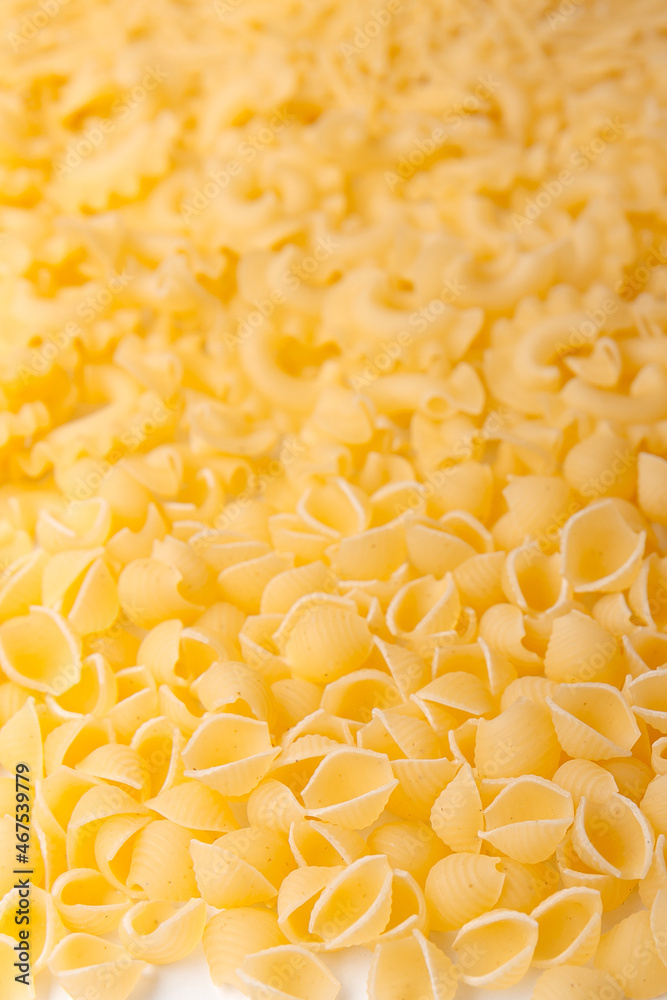 Background of various kinds of pasta. Uncooked food background or texture close up Background of various kinds of pasta. Uncooked food background or texture close up
