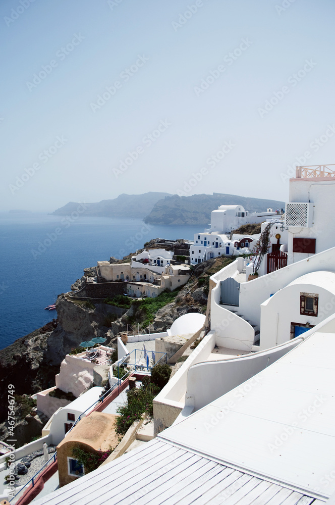 Fototapeta premium GREECE, SANTORINI: Scenic seaside landscape view of white classics buildings on the rocky slopes of Thira island 