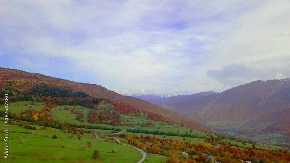Flying on drone over autumn mountains with serpentine mountain road and forest. Georgia, Svaneti. drone flies over beautiful landscape autumn colorful forest, dangerous road for professional drivers Flying on drone over autumn mountains with serpentine mountain road and forest. Georgia, Svaneti. drone flies over beautiful landscape autumn colorful forest, dangerous road for professional drivers