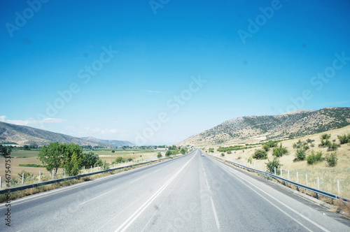 GREECE: Scenic landscape view with the road and mountains in the background  © Marry