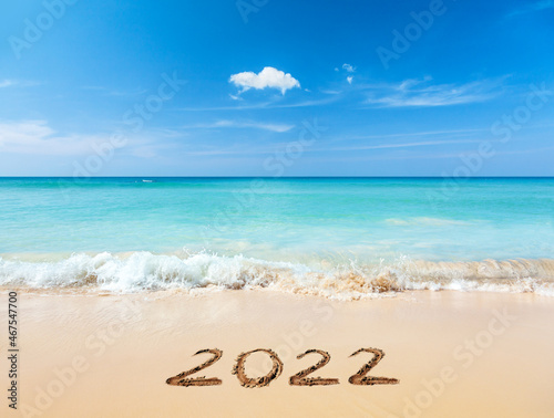 2022 written on sandy beach