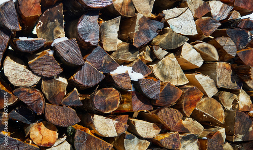 Logs with snow. Winter logs. Lumber for the winter