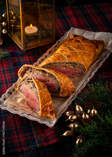 Beef wellington or boeuf en crout cut into slices on christmas background. photo