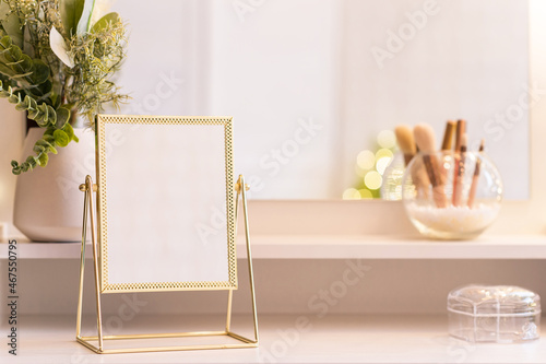 Reflection of christmas tree, light bulbs, in table mirror on woman dressing table with make up accessories photo