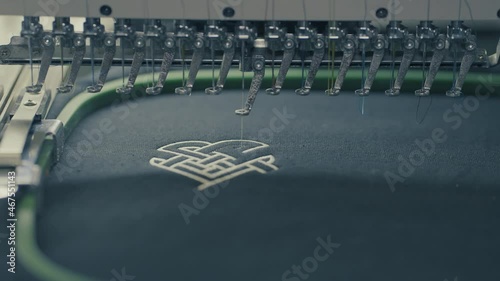 Industrial sewing machine needle creating a design on a shirt.