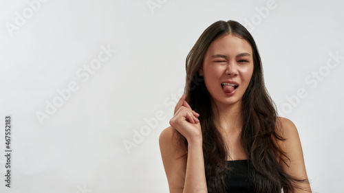 Portrait of smiling Asian woman near blank copy space