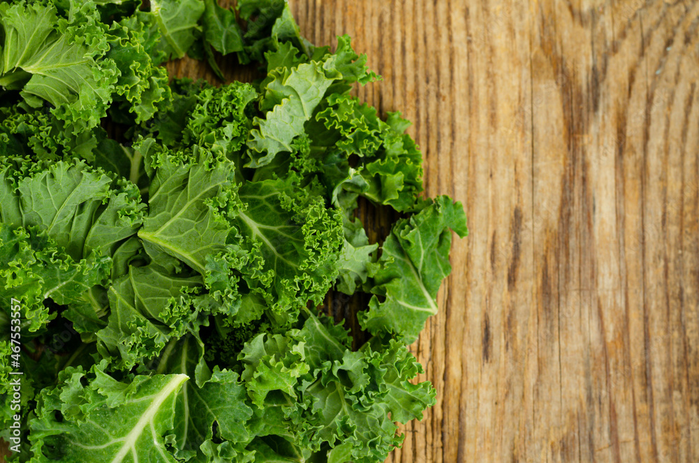 Fresh green sabellica leaves on wooden background, healthy organic food. Fresh green sabellica leaves on wooden background, healthy organic food.