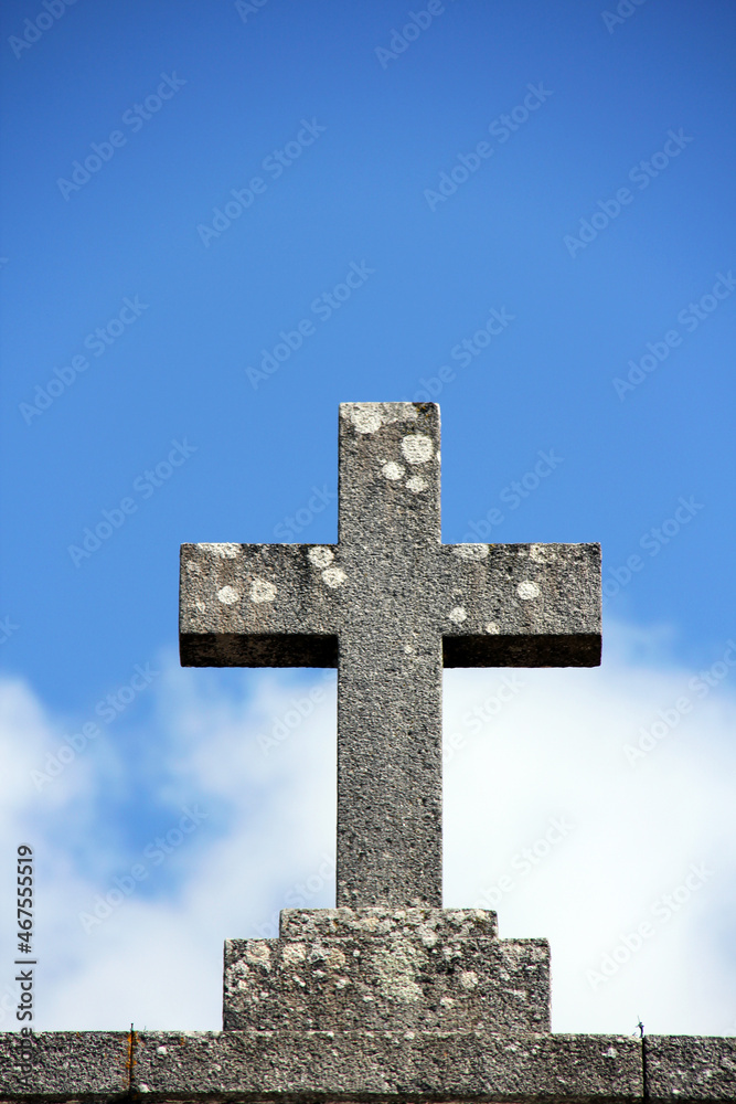Beautiful Old stone cross with blue sky background.