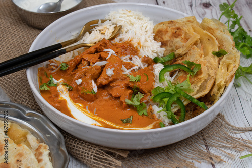 Vegetarian butter chicken made with seitan, served with rice, paratha