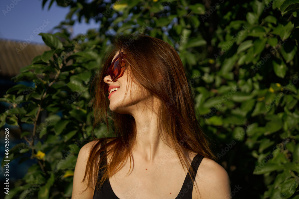 Fototapeta premium pretty woman in swimsuit and sunglasses summer tropics