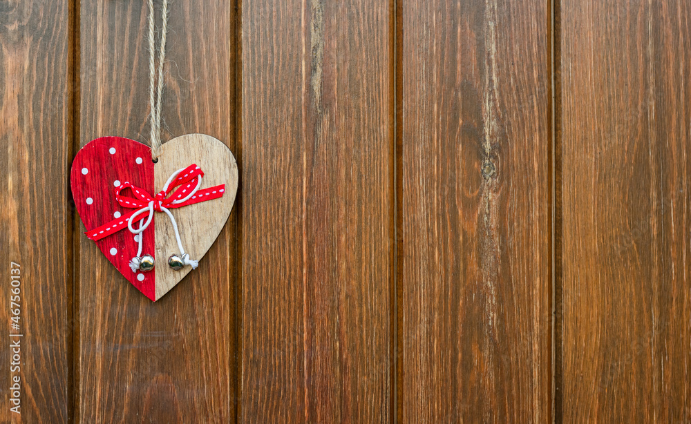 Decorative christmas heart on a rustic wooden background with copy space