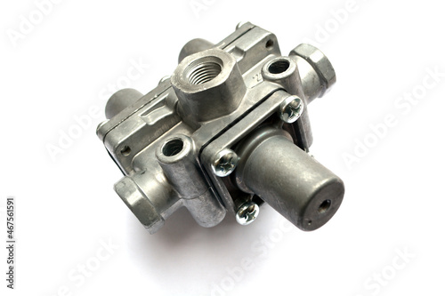 Protective valve of the triple pneumatic brake system of the truck on a white background. New spare parts.