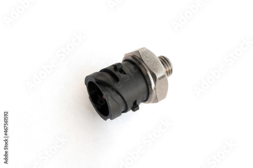 Oil pressure sensor of car isolated on white background. New spare parts.