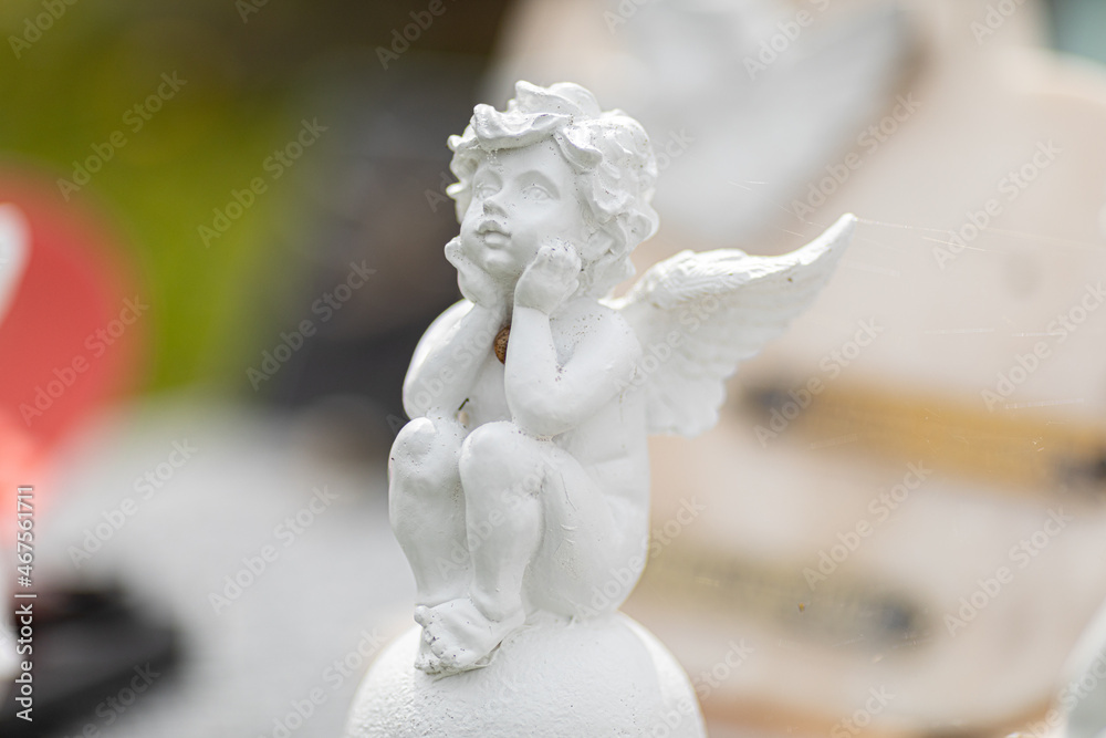 Angel sculptures on gravestone in the cemetery Angel sculptures on gravestone in the cemetery
