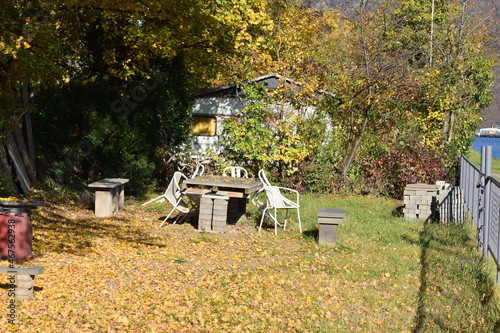 Tisch und Stühle vor einem Campingwagen im Herbstwald