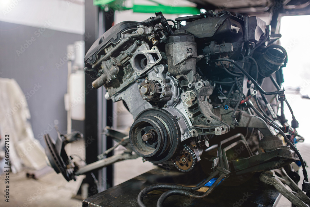 repair of the engine in a car service, the engine removed from the body.