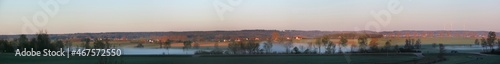 Panoramic view of the lowlands of Altmühl river valley on a foggy spring morning with the villages of Stadel, Hilsberg and Aurach in the background, Franken region in Germany