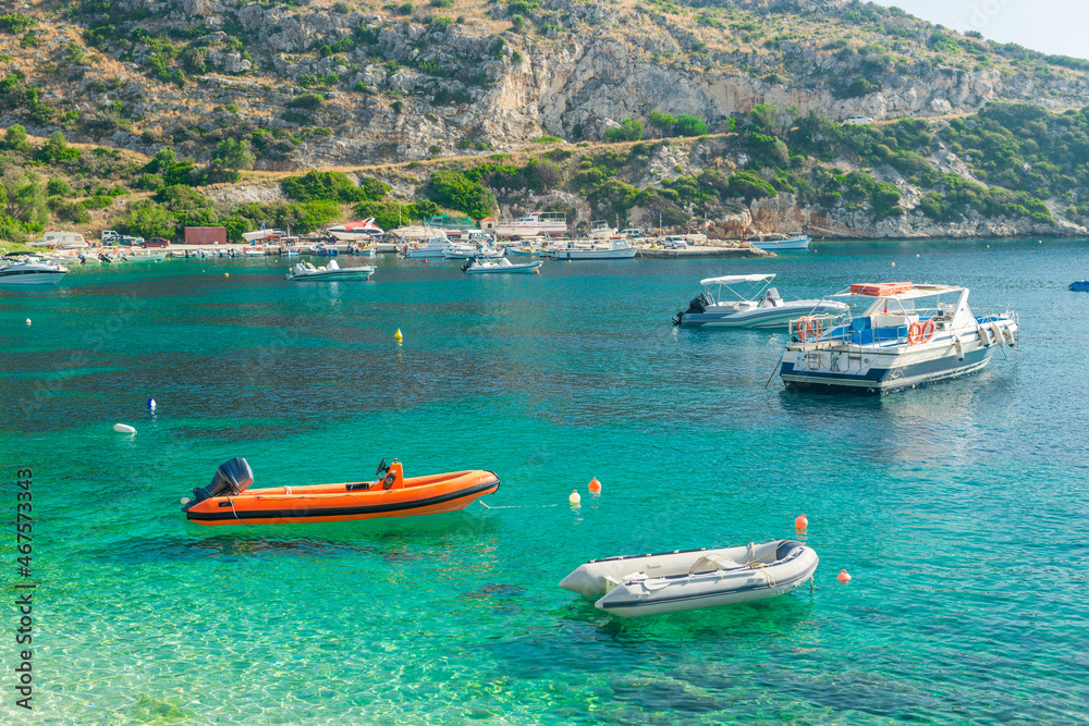 boats sway on the turquoise waves of the Ionian sea of Greece in sunny weather