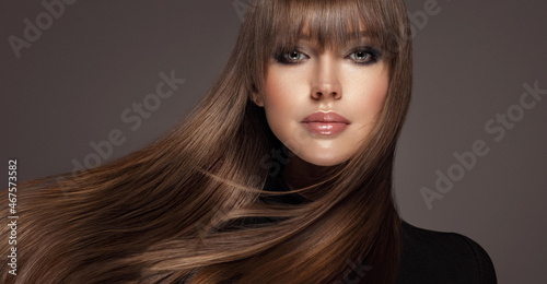 Beautiful model woman with shiny  and straight long hair. Keratin  straightening. Treatment, care and spa procedures. Beauty  girl smooth hairstyle photo