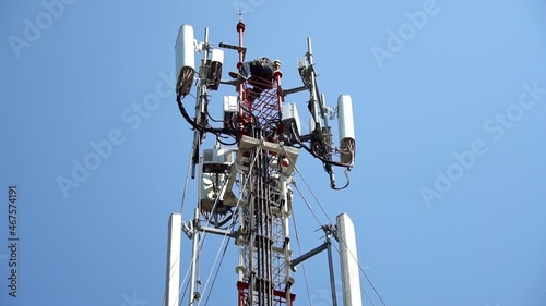 workers are working at 5g antenna tower for maintaining.serves cellular antenna, technician worker repair telecommunication tower on sunlight at background.	