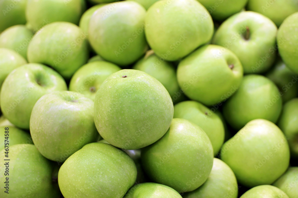 Green apples close up for background. Fresh harvest, ripe fruits on farm market Green apples close up for background. Fresh harvest, ripe fruits on farm market