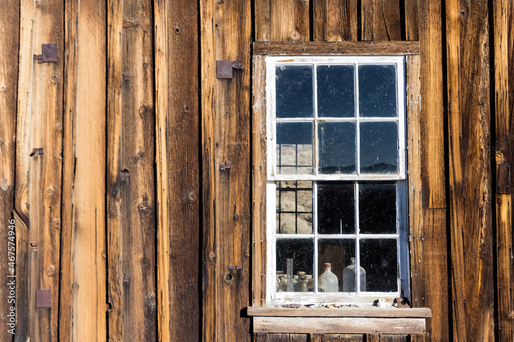 Window frame in a wood building weathered by time landscape
