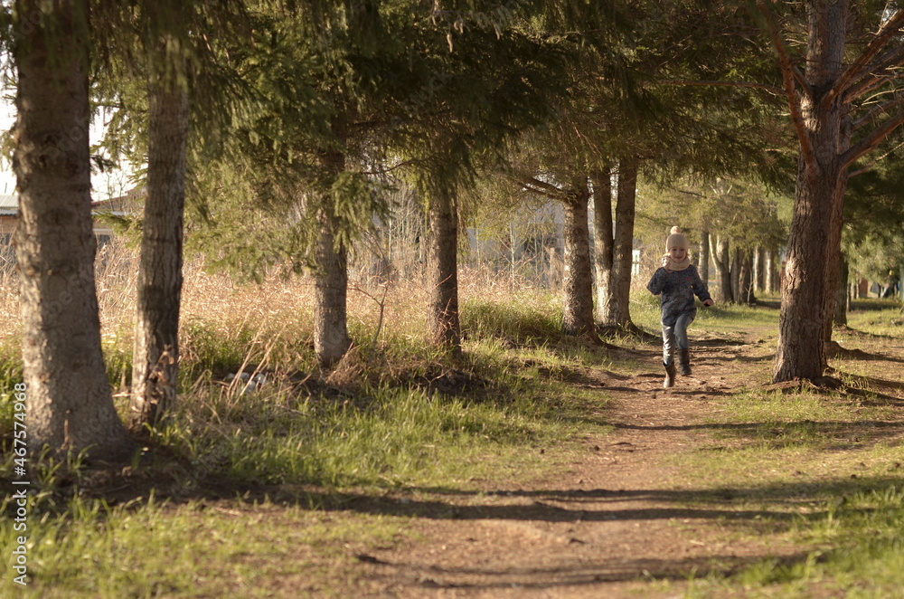 a girl runs through the forest